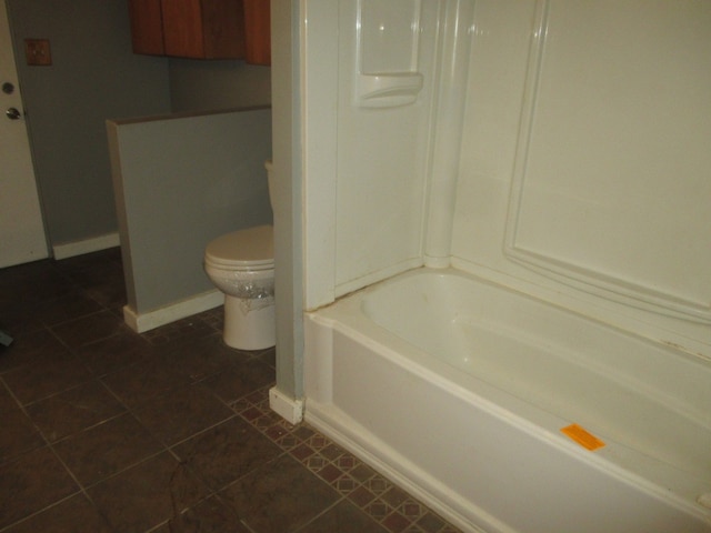 bathroom with tile floors and toilet