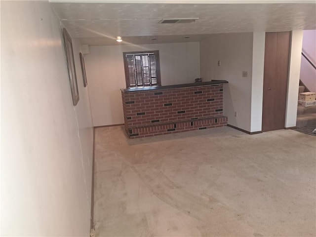 unfurnished room featuring stairs, a dry bar, and visible vents