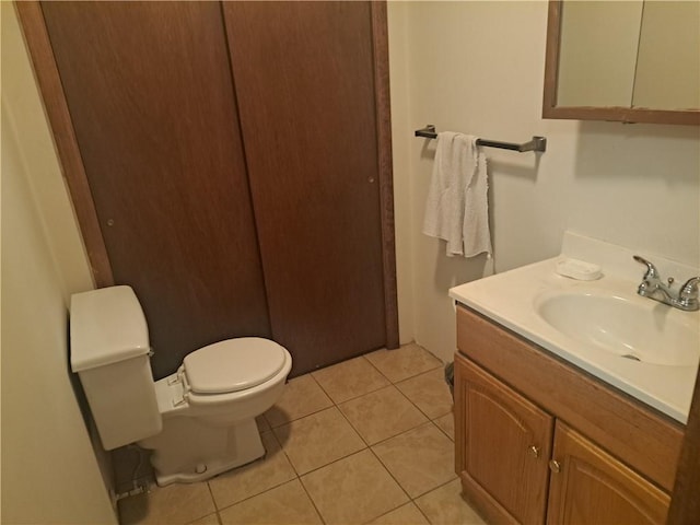 bathroom with tile patterned flooring, toilet, and vanity