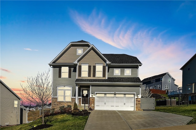 craftsman-style house featuring a garage and a lawn