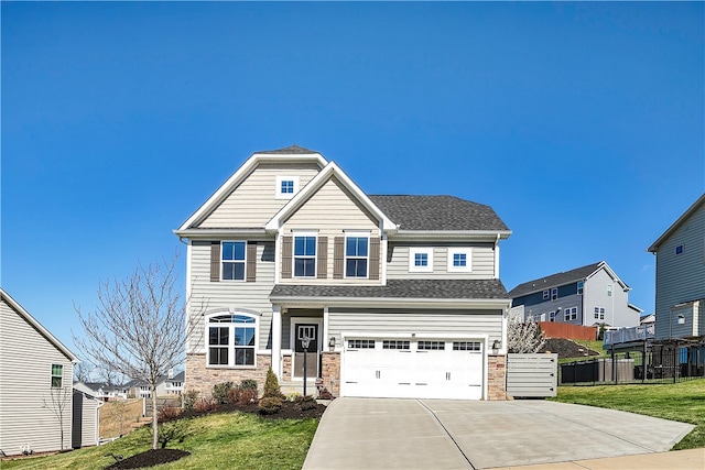 craftsman house with a garage and a front lawn