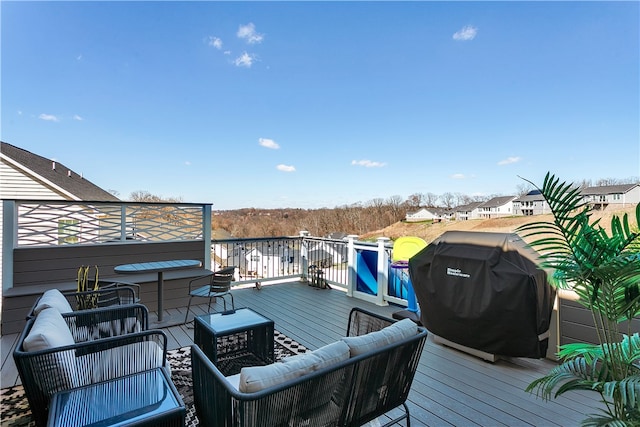 wooden terrace featuring grilling area and outdoor lounge area