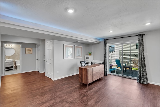 home office featuring dark wood-type flooring and a textured ceiling