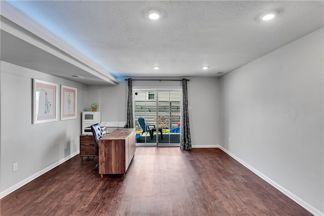 home office featuring dark hardwood / wood-style flooring and a textured ceiling