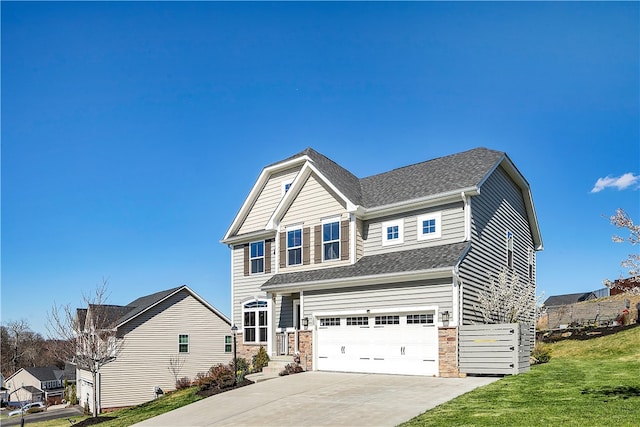 craftsman-style house featuring a garage and a front yard