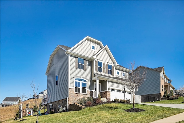 view of front of property with a front yard and a garage