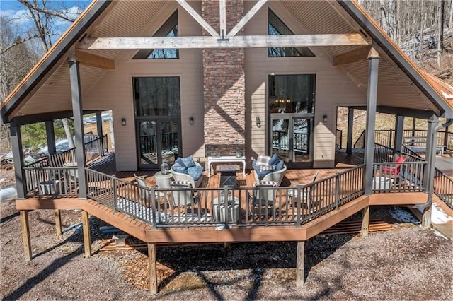 back of property featuring a wooden deck and an outdoor living space