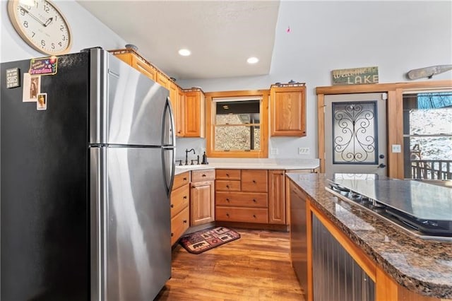 kitchen with sink, hardwood / wood-style floors, stainless steel fridge, and a healthy amount of sunlight