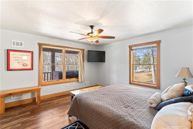 bedroom with ceiling fan and dark hardwood / wood-style flooring