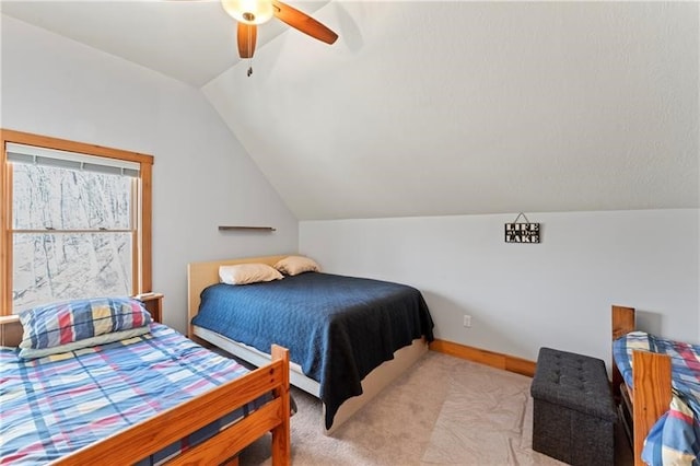 bedroom featuring light carpet, ceiling fan, and vaulted ceiling