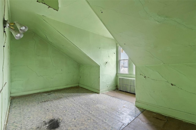 additional living space with lofted ceiling and radiator