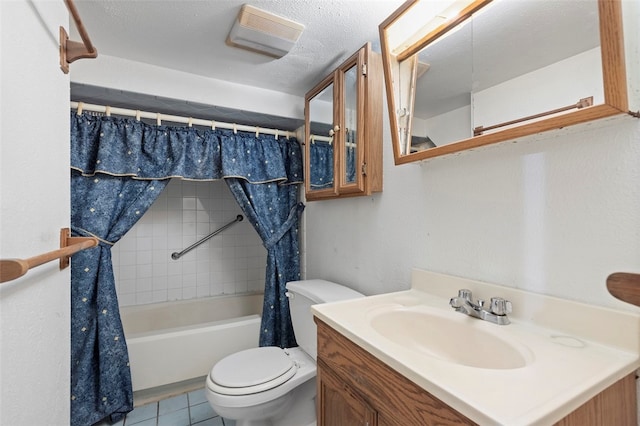 full bathroom featuring vanity, shower / tub combo with curtain, tile floors, a textured ceiling, and toilet