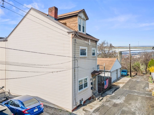 view of side of home featuring a garage