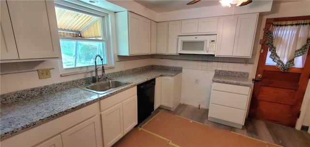 kitchen featuring white cabinets, ceiling fan, decorative backsplash, wood-type flooring, and sink