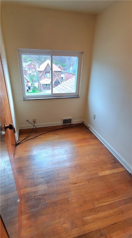 unfurnished room with plenty of natural light and light hardwood / wood-style floors