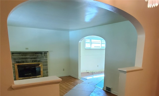 entryway with hardwood / wood-style flooring and a fireplace