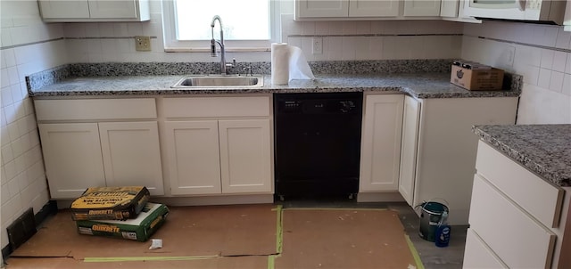 kitchen with sink, dishwasher, light stone counters, and white cabinets