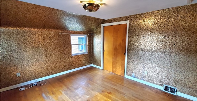 unfurnished bedroom featuring hardwood / wood-style flooring and a closet