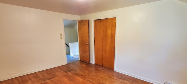 unfurnished bedroom with a closet and wood-type flooring