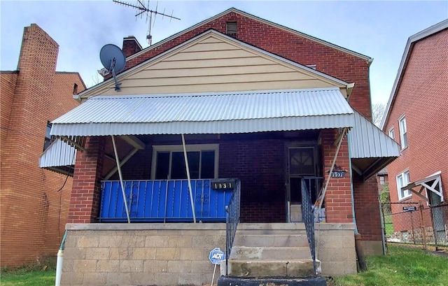 view of front of property featuring a porch and brick siding