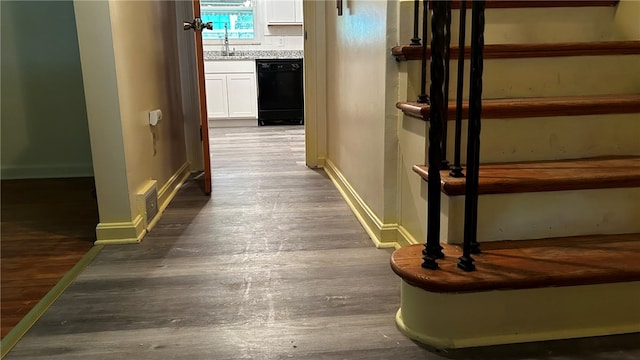 corridor featuring sink and hardwood / wood-style floors