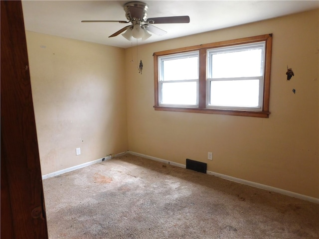 carpeted empty room with ceiling fan