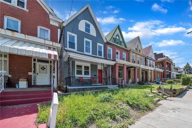 townhome / multi-family property with covered porch