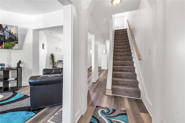 stairs with dark wood-type flooring