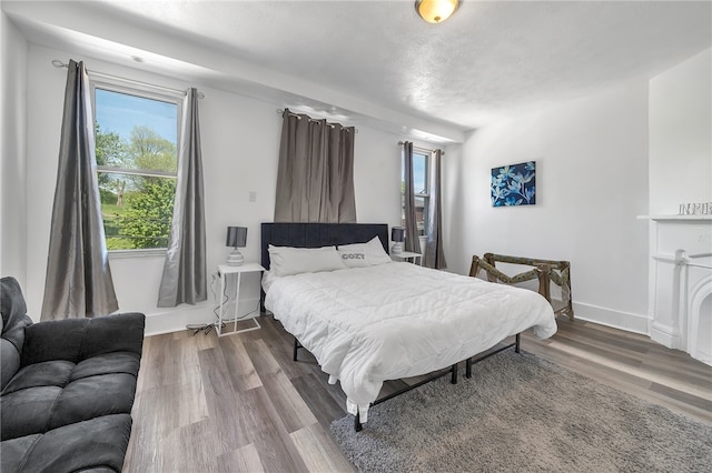 bedroom with dark hardwood / wood-style floors