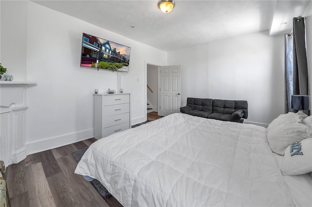 bedroom with dark hardwood / wood-style floors