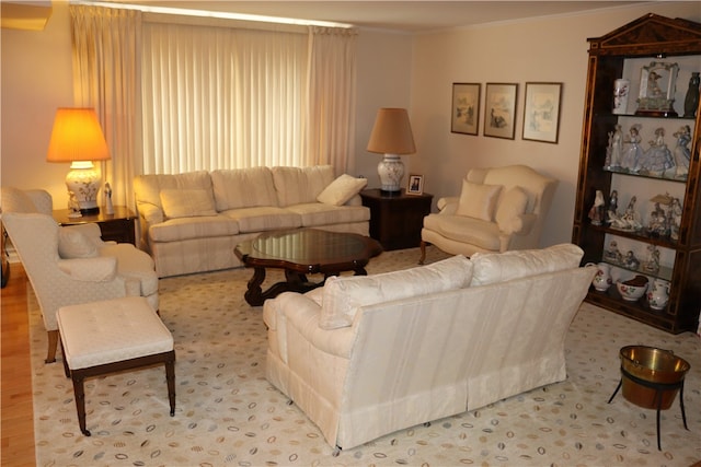 living room with hardwood / wood-style flooring and ornamental molding