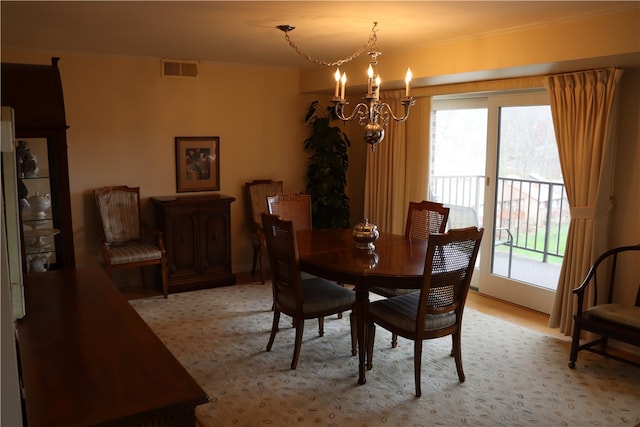 dining space with ornamental molding, a healthy amount of sunlight, and a chandelier