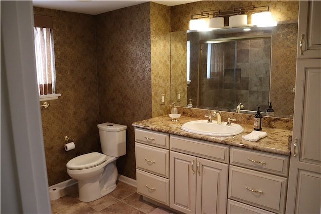 bathroom featuring vanity, tile patterned flooring, and toilet