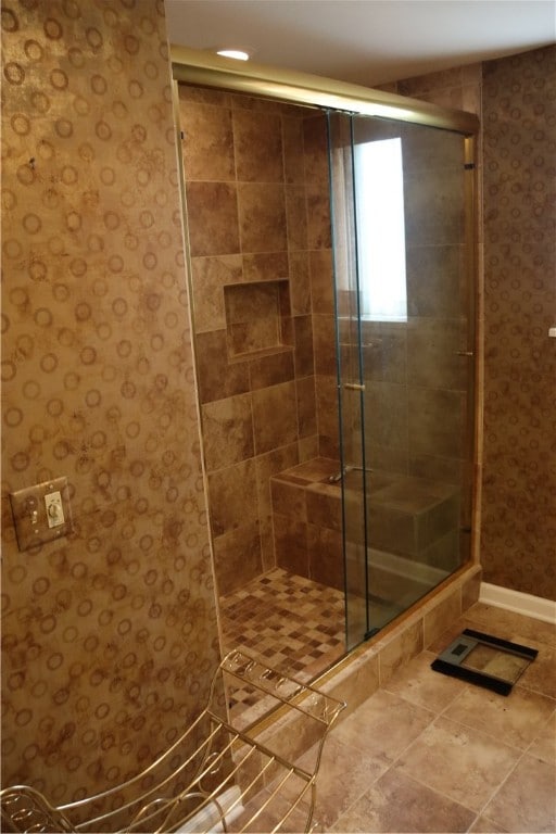 bathroom with tile patterned floors and walk in shower