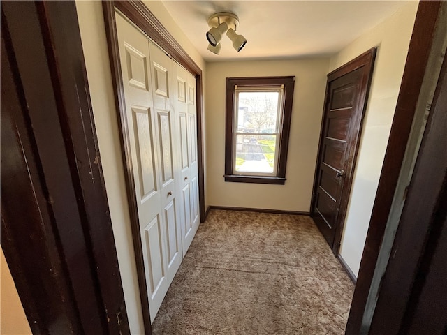 hall featuring dark colored carpet