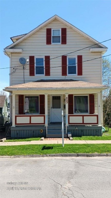 front of property featuring a porch and a front lawn