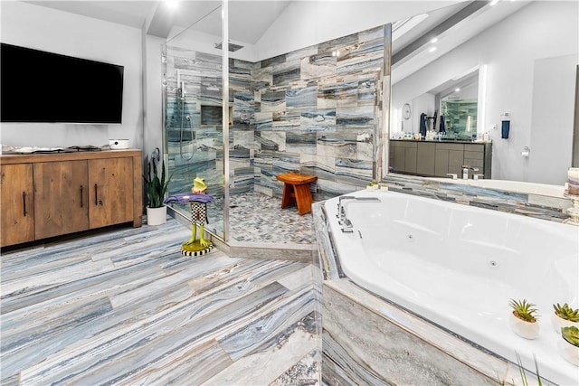 bathroom with vanity, independent shower and bath, and vaulted ceiling