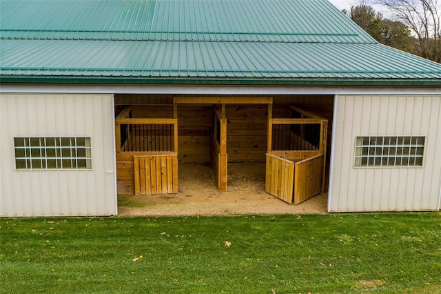 view of horse barn with a yard and an outdoor structure