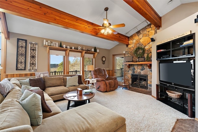 carpeted living room featuring a fireplace, ceiling fan, and vaulted ceiling with beams