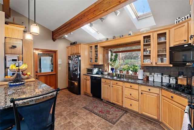 kitchen featuring lofted ceiling with skylight, dark tile flooring, backsplash, decorative light fixtures, and black appliances