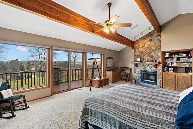 carpeted bedroom with a stone fireplace, lofted ceiling with beams, ceiling fan, and access to exterior