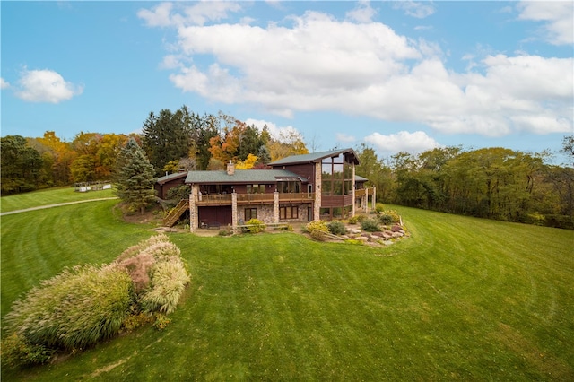 rear view of property with a lawn