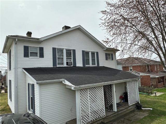 rear view of house with a yard