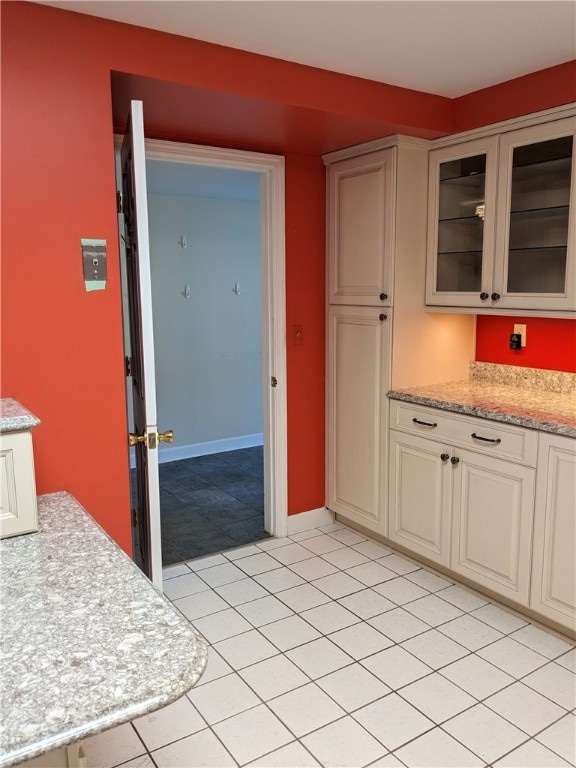 kitchen with light tile floors and light stone countertops