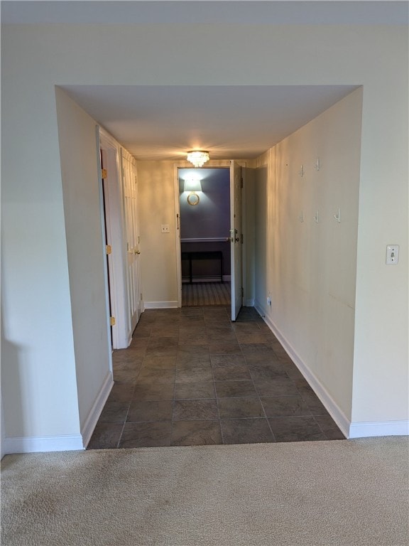 corridor with dark tile flooring