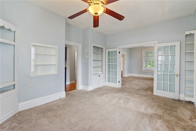 unfurnished bedroom featuring ceiling fan, french doors, and light carpet