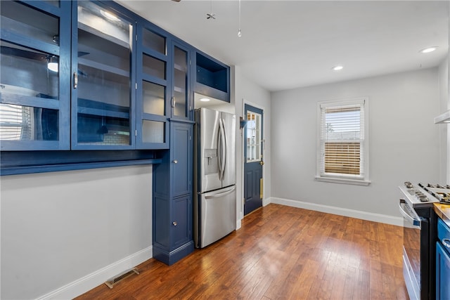 kitchen featuring white electric stove, stainless steel fridge with ice dispenser, dark hardwood / wood-style floors, and blue cabinetry