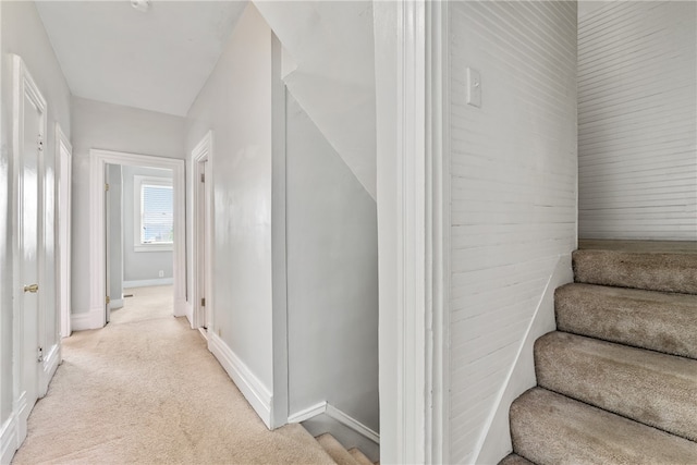 staircase with light colored carpet and vaulted ceiling