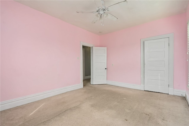 carpeted empty room featuring ceiling fan