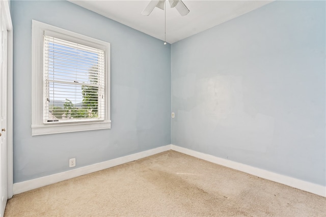 unfurnished room with ceiling fan and light carpet